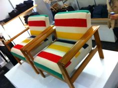 a colorful striped chair sitting on top of a white platform