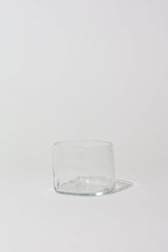 an empty glass sitting on top of a white table