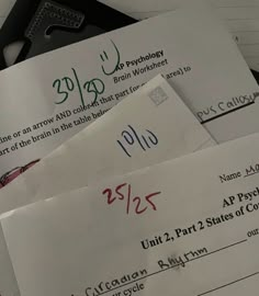 several pieces of paper with numbers and symbols on them sitting next to some other papers