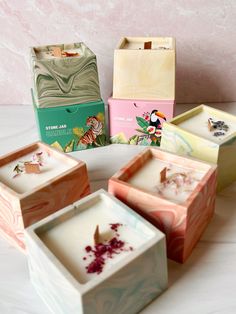 four boxes with different designs on them sitting on a table