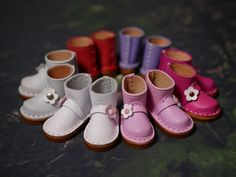 several pairs of baby shoes lined up in a row