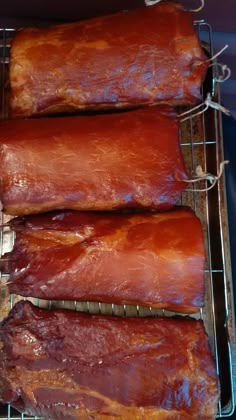 three ribs are on a rack with some meat in them