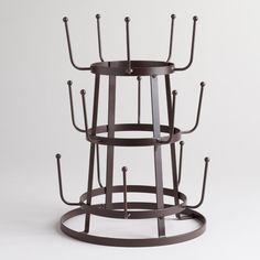 a black metal rack with four candles on it and measurements for each candle holder in the same