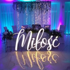 the word miffoss is lit up in front of a table with flowers and candles