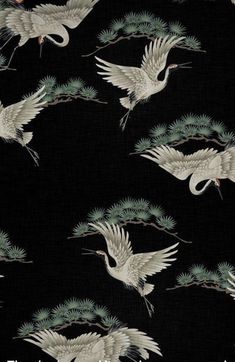 a black background with white cranes and pine needles on it's sides, all flying in the same direction