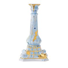 a blue and gold vase sitting on top of a table