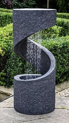 an outdoor fountain with water coming out of it