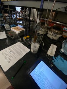 an electronic device sitting on top of a table next to some papers and other items