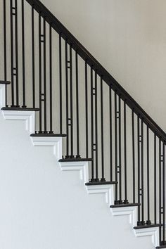 a cat is sitting on the handrails of a stair case in a house