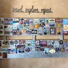 a wall covered in pictures and magnets with the words travel explore repeat