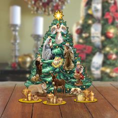 a christmas tree with nativity figurines around it