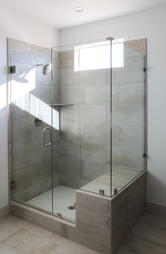 a walk in shower sitting inside of a bathroom