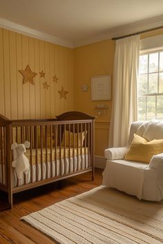 a baby's room with yellow walls and white furniture