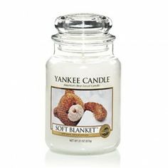 a yankee candle with a teddy bear on it's face and the words soft blanket