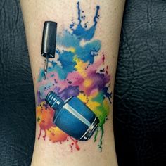 a colorful tattoo with a bottle and paint splattered on it