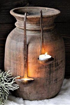 a candle is lit in a clay pot