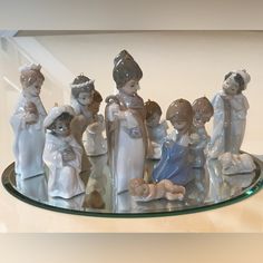 a group of figurines sitting on top of a glass shelf