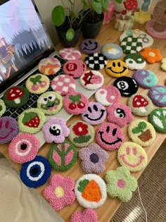 a wooden table topped with lots of cupcakes covered in crocheted designs