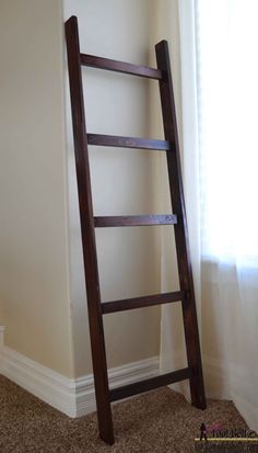 a ladder leaning up against the wall in a room with carpeted floor and white walls