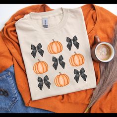 Cozy soft style cotton t-shirt. Kick off fall with this pumpkins and black bows T-shirt. Hand designed and made to order. Tshirt Painting, Black Bows, Fall Shirt, Black Bow, Fall Shirts, Hand Designs, Soft Style, Diy Clothes