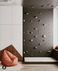 a room that has some rocks on the wall and a bean bag chair in front of it