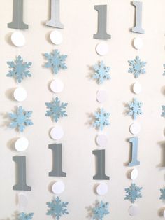 a white wall with blue snowflakes on it and the numbers 1 - 3