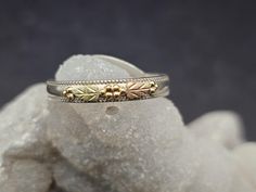 This listing is for a genuine Black Hills Gold and Sterling Silver ring.  This ring comes from an old collection, hence the cheaper price.  Approximate Measurements: Size:  10 1/2 It sits up about 5mm high. There are 2 of the traditional Black Hills Gold leaves on this design.  It is stamped inside with the sterling silver mark and 10k gold. *Please contact us if you have any questions. We do not allow refunds or exchanges unless it is under exceptional circustances (this will incur a 5% restocking fee). So we highly encourage you to read the measurements and description. I will be more than happy to answer any questions or provide more information/photos if needed. *Shipping days are Mondays, Thursdays, and Fridays. Vintage Black Engraved Ring Stamped 925, Vintage 925 Stamped Heart Ring, Black Hills Gold Engagement Rings, Black Hills Gold Wedding Rings, Black Hills Gold Rings Vintage, Black Hills Gold Rings, Old Rings, Black Hills Gold, Black Hills