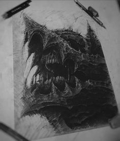 a black and white drawing of a skull with sharp teeth on a piece of paper