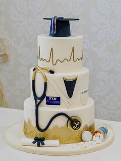 a three tiered cake with a stethoscope and medical equipment on top