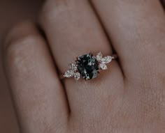 a woman's hand with a black and white diamond ring