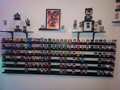 the shelves are filled with many different action figures and figurines on top of them