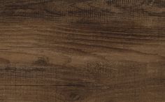 a close up view of a wood floor with dark brown stain on the top and bottom