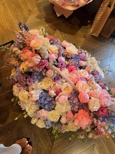 an umbrella covered in flowers on the floor