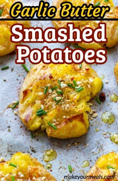 garlic butter smashed potatoes on a baking sheet with text overlay that reads garlic butter smashed potatoes