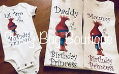 two baby onesuits with the words daddy and mommy printed on them, sitting next to each other