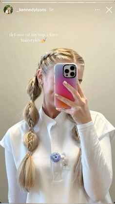 a woman taking a selfie with her cell phone in front of her face while wearing a white shirt