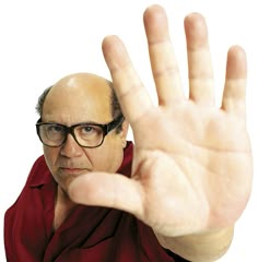 a man wearing glasses making the vulcan sign with his hand