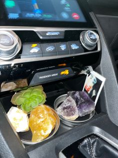 the interior of a car with various items in it, including rocks and succulents