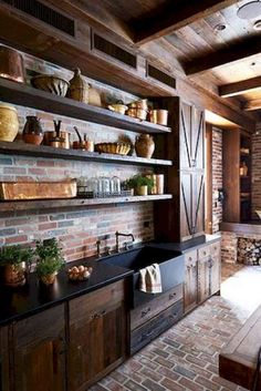 a kitchen with brick walls and wooden shelves