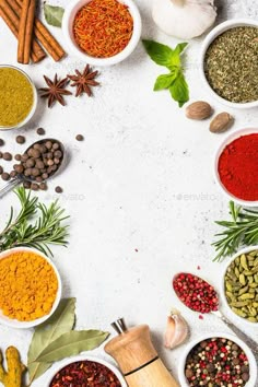 various spices and herbs arranged in bowls on a white background - stock photo - images