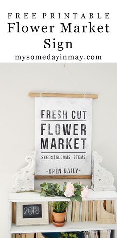 a shelf with flowers and books on it in front of a sign that says fresh cut flower market