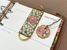 a book with a keychain attached to it sitting on top of a binder