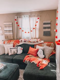 a living room filled with lots of furniture and pillows on top of it's couches