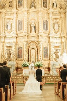 the bride and groom are standing at the alter in front of the church's altar