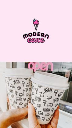 two ice cream cups are being held up in front of a pink sign that says modern cone