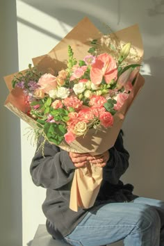 a person sitting down holding a bouquet of flowers