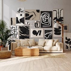 a living room filled with lots of art on the wall above a wooden coffee table