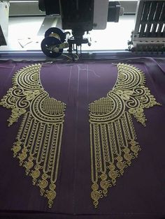 an embroidery machine with gold designs on it