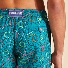 Embroidered men swim shorts, limited productionMen swim shorts with elastic waistband with drawstring and silver tips (engraving 925 certified)Side pockets and back pocket with Turtle personalized round snap buttonTwo back eyeletsSide leg length in M: 39.5 cmFully lined with water-resistant mesh lining (100% polyamide)Noumea Sea Men Swim ShortsMen Embroidered Swim Shorts100% Recycled Polyamide  To take care of your adored men swim shorts, we advise you to follow our suggestions below:Rinse your embroidered swim shorts for men with fresh water after each use.When you wash your men swimwear, use a machine rather than doing it by hand, choose a delicate cycle at 30°C with a mild detergent and wash it with similar colors.Do not use oxygenated or chlorine based bleach/ stain removers, your embr Green Swim Trunks With Built-in Shorts For Swimming, Multicolor Moisture-wicking Swim Trunks For The Beach, Tropical Swim Trunks With Built-in Shorts For Surfing, Father And Son Clothing, Multicolor Swim Trunks With Built-in Shorts For Swimming, Playful Cotton Swim Trunks With Built-in Shorts, Luxury Swimwear, Swim Brief, Boys Swimwear