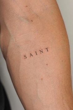 the word saint written on someone's arm